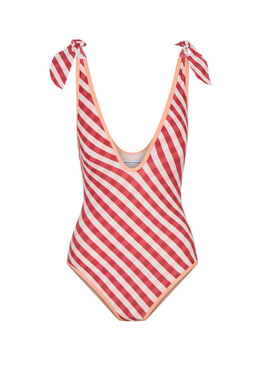 The Gingham V Neck Onesie is made from soft matte spandex with a custom Bohemian Traders print, designed to flatter every form. Featuring removable cups, tie straps, and full lining for structure and support, it offers confidence in motion. Pair with the Frayed Sarong for a coordinated, size-inclusive resort look that transitions beautifully from beach to bar.