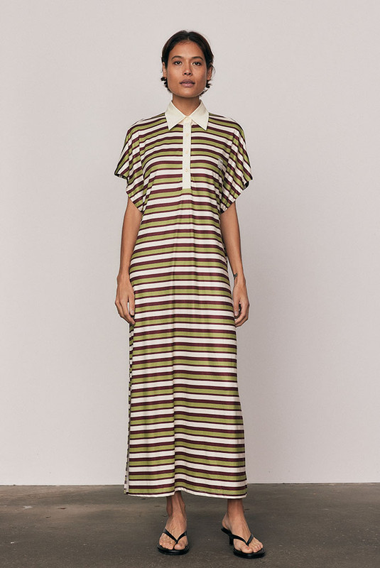 The Maggie T-Shirt Dress redefines relaxed polish. Crafted from silky striped polyester, it features a contrast collar, embroidered logo, and fluid drape that moves with ease. Its mid-length silhouette and effortless comfort make it perfect for day-to-night styling. Casual, confident, and crafted for women who favour style with soul.