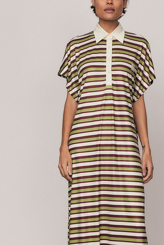 The Maggie T-Shirt Dress redefines relaxed polish. Crafted from silky striped polyester, it features a contrast collar, embroidered logo, and fluid drape that moves with ease. Its mid-length silhouette and effortless comfort make it perfect for day-to-night styling. Casual, confident, and crafted for women who favour style with soul.