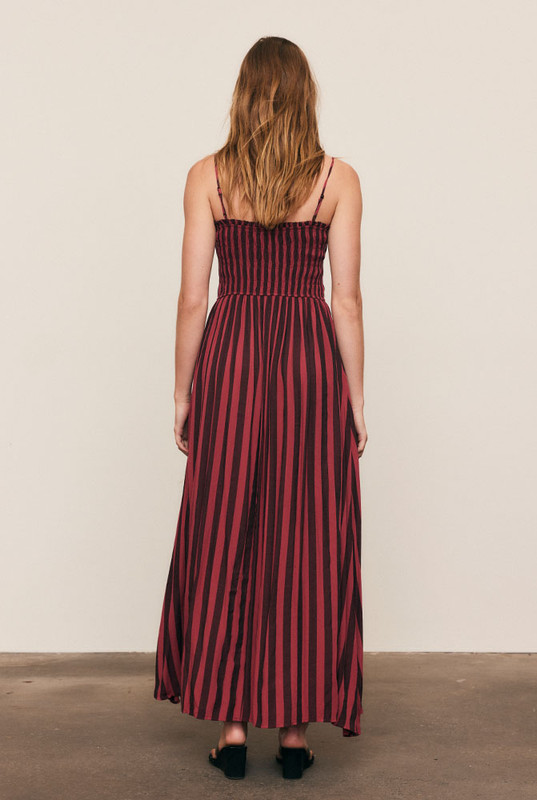 Soft and fluid, the Ruched Slip Maxi Dress is crafted from draped viscose rayon in Bohemian Traders’ custom magenta stripe print. A ruched bodice flatters the form before flowing into an A-line skirt that moves with ease. Effortless femininity meets artful design - a timeless piece for long lunches, warm evenings, and summer celebration.