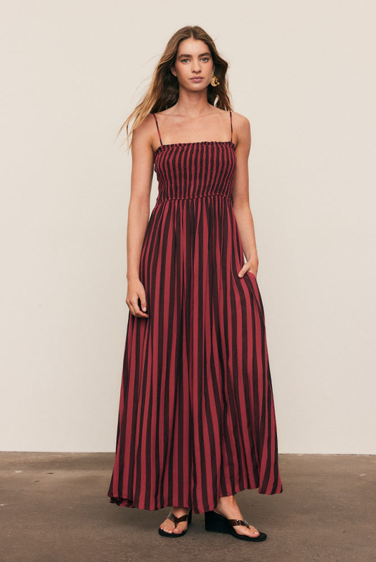 Soft and fluid, the Ruched Slip Maxi Dress is crafted from draped viscose rayon in Bohemian Traders’ custom magenta stripe print. A ruched bodice flatters the form before flowing into an A-line skirt that moves with ease. Effortless femininity meets artful design - a timeless piece for long lunches, warm evenings, and summer celebration.