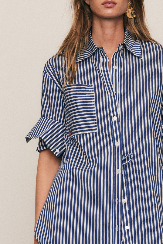 Timeless and versatile, the Stripe Classic Shirt is crafted from a premium Rayon–Tencel blend in a crisp stripe that drapes with ease. Designed in an oversized silhouette with a classic collar and subtle red Bohemian Traders embroidery, it pairs perfectly with the matching Stripe Short for an elevated, coordinated take on modern summer shirting.