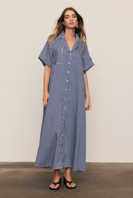 A reinvention of our best-selling Opera Shirt Dress, this new-season update arrives in a soft Rayon–Tencel blend with short sleeves and a camp collar, reimagined for high summer. Refined red Bohemian Traders embroidery adorns the chest, while the fluid stripe fabric and relaxed tailoring offer effortless versatility — the perfect balance of structure and ease.