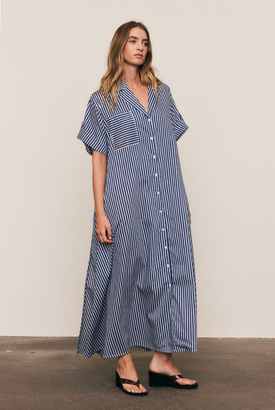 A reinvention of our best-selling Opera Shirt Dress, this new-season update arrives in a soft Rayon–Tencel blend with short sleeves and a camp collar, reimagined for high summer. Refined red Bohemian Traders embroidery adorns the chest, while the fluid stripe fabric and relaxed tailoring offer effortless versatility — the perfect balance of structure and ease.