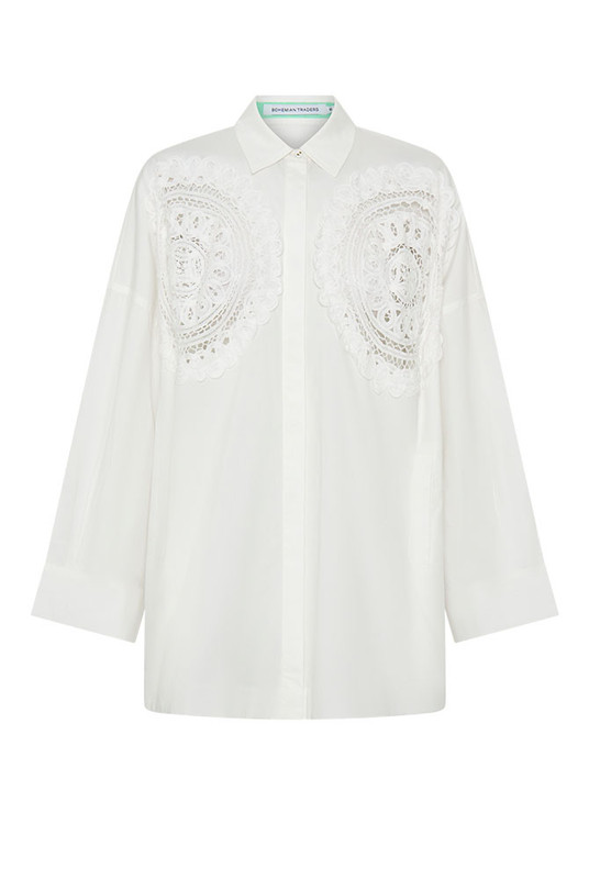 A fresh interpretation of feminine tailoring, the Crochet Oversized Shirt blends crisp structure with delicate detail. Crafted from pure cotton poplin in clean white, its oversized silhouette is elevated by intricate lace crochet at the chest—an artisanal touch that nods to vintage romance.