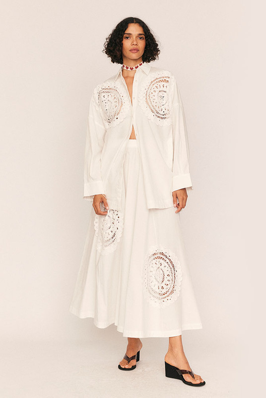 A warm-weather statement with timeless ease, the Crochet Circle Skirt is cut from crisp white cotton poplin and adorned with delicate lace crochet detailing for a softly romantic finish. The circular silhouette creates a natural fullness that moves beautifully with every step, while an elasticated waistband ensures all-day comfort.