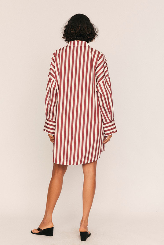 Tailored ease with a playful twist, the Tie Waist Shirt Dress blends crisp structure with easy dressing. Made from lightweight cotton poplin in bold maroon and white stripes, this mini dress offers a relaxed, oversized fit that cinches effortlessly with a fully detachable self-tie waist belt.