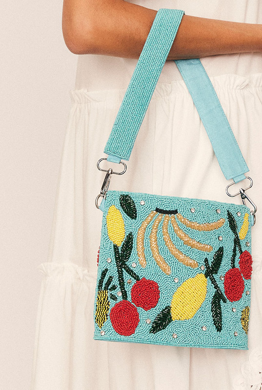 A joyful celebration of craftsmanship, the Fruity Beaded Handbag is an artisanal piece that turns every outfit into a statement. Featuring a hand-beaded fruit motif, multi-coloured tassels, and a removable wide shoulder strap—also intricately beaded—this compact carryall is full of character.
