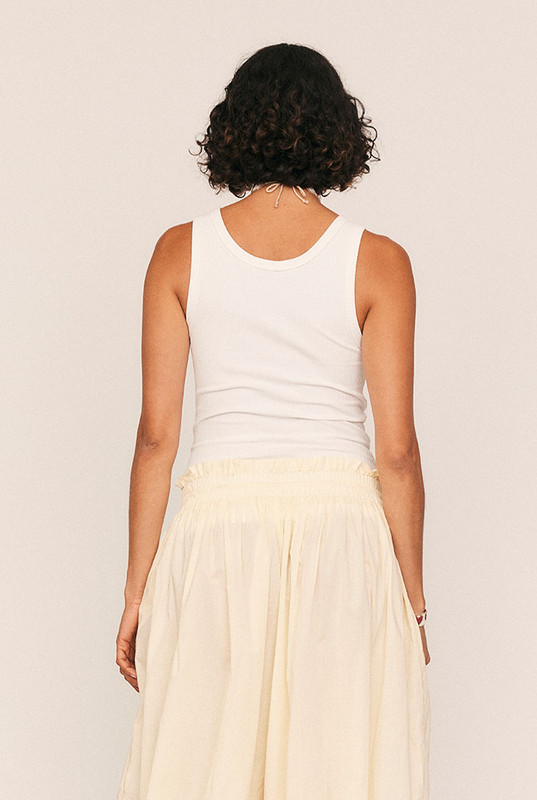 A modern wardrobe essential reimagined with quiet confidence. The Scoop Neck Tank is cut from soft, premium ribbed cotton with just the right amount of stretch, offering a figure-skimming silhouette that flatters every shape. With a rounded scoop neckline, sleek self-binding, and functional button detailing, it transitions effortlessly from layering piece to stand-alone staple.
