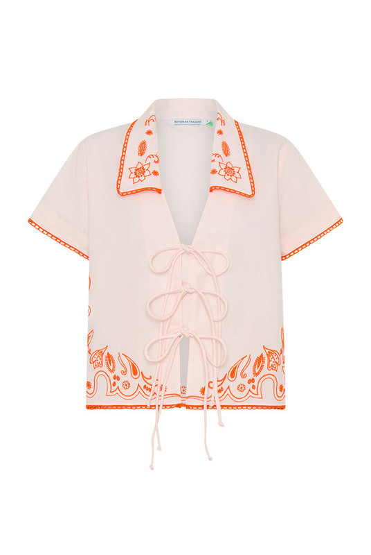 Sweet yet spirited, the Bonnie Embroidered Top is a cropped cotton poplin blouse brought to life with bold, artisanal embroidery. Set against a dreamy pastel pink base, vibrant orange threadwork creates a striking contrast—evoking a sense of playful femininity with a handcrafted feel.