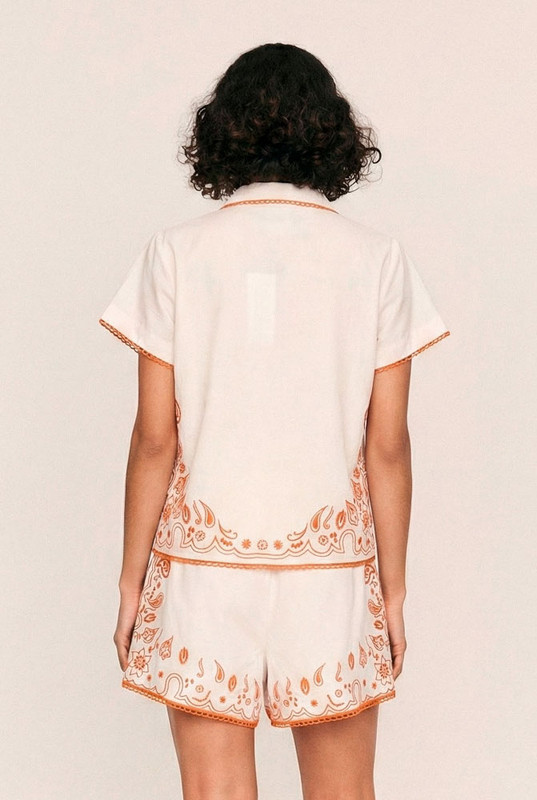 Sweet yet spirited, the Bonnie Embroidered Top is a cropped cotton poplin blouse brought to life with bold, artisanal embroidery. Set against a dreamy pastel pink base, vibrant orange threadwork creates a striking contrast—evoking a sense of playful femininity with a handcrafted feel.