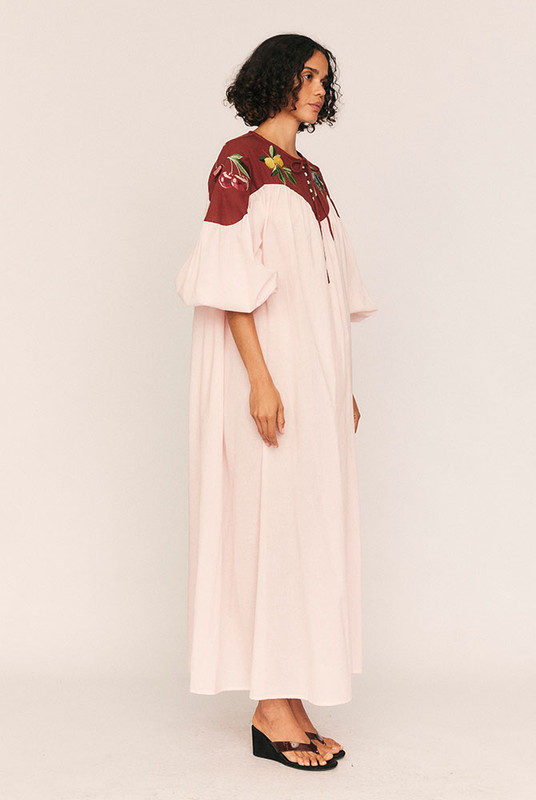 Whimsical yet grounded, the Fruito Bib Smock brings artistry to everyday wear. Crafted from soft cotton voile with a textured cotton yoke, this oversized silhouette is adorned with embroidered fruit motifs—a signature touch from Bohemian Traders’ in-house design team.