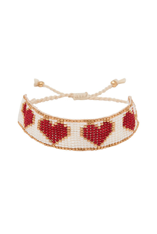 Sweet and striking, the Loveheart Beaded Bracelet is an artisanal piece that adds charm to every wrist. Hand-beaded in a bold heart design, it features a vibrant mix of red, gold, and white glass beads intricately woven into a timeless symbol of love.