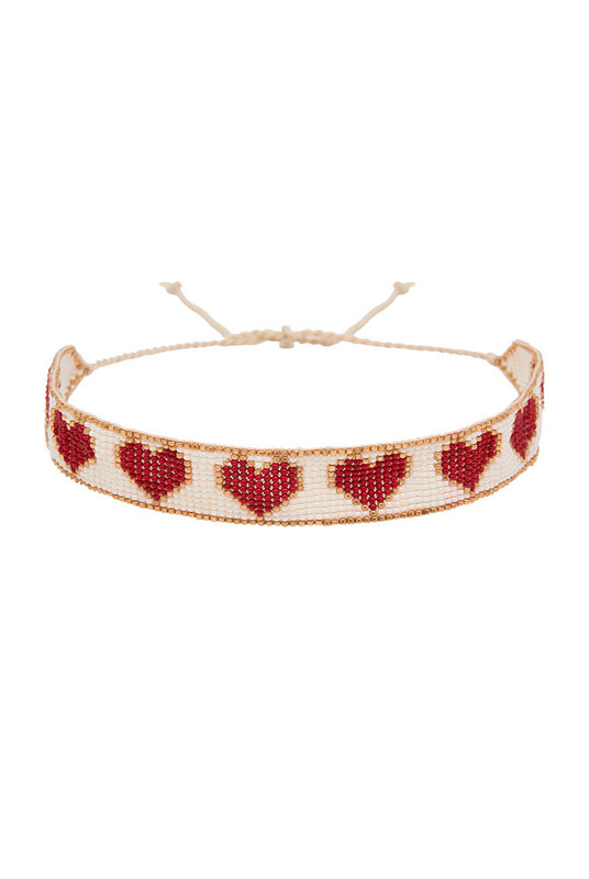 Romantic with a playful edge, the Loveheart Beaded Choker is handcrafted in a vibrant heart motif using red, gold, and white glass beads. Woven with care and artistry, this statement piece sits delicately at the neckline—adding a bold, personal touch to any look.