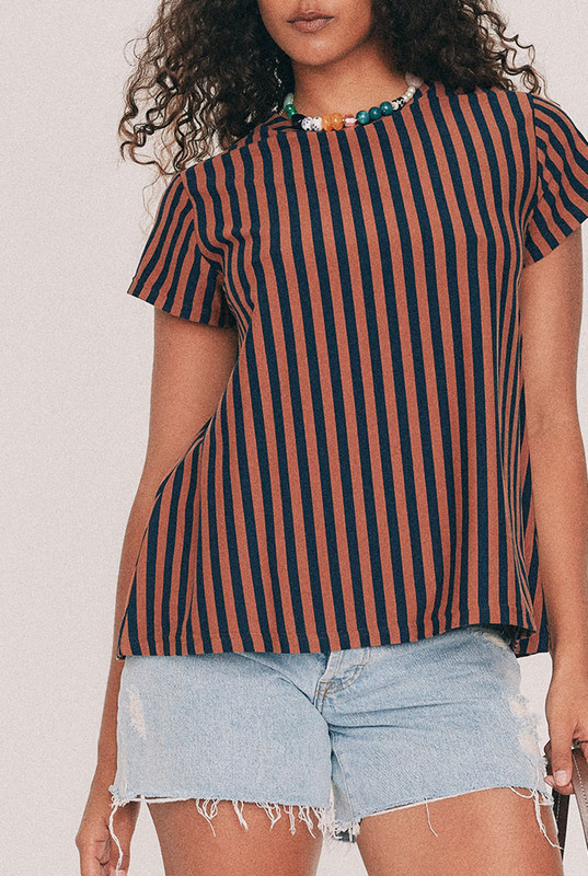 Cut from yarn dyed cotton stripe jersey, this striped tee has a relaxed swing silhouette with cap sleeves. Machine washable and quietly indispensable: wear it with the denim short all summer. Designed from a 6 to a 22.