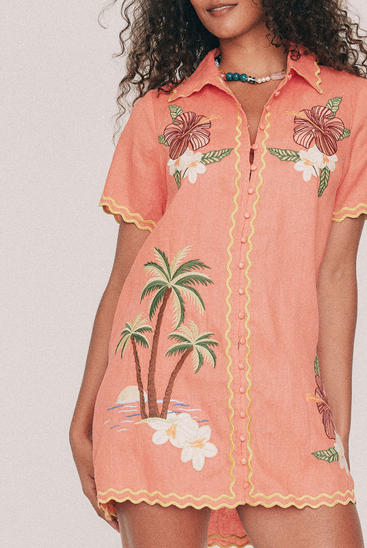 Cut from premium linen, this coral mini shirt dress is traced with hand-drawn tropical embroidery along a scalloped silhouette. Straight through the body with short sleeves, it buttons the whole way down, so it works as a dress, as a jacket over a slip, or thrown over swimmers on the walk back from the water. True to size, designed from a 6 to a 22.