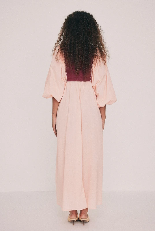 Cut from soft cotton voile, this boho coral maxi dress falls loose from an embroidered linen bib. Hibiscus and frangipani illustrations, drawn by hand in our Central Coast studio, trace the yoke. A split V neckline and long sleeves gathered at the cuff ensure ease of wear, while pockets set into the side seams provide practicality. Made for hot days that turn into breezy evenings, for a long lunch or a week somewhere warm. Designed from a 6 to a 22.