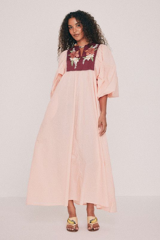 Cut from soft cotton voile, this boho coral maxi dress falls loose from an embroidered linen bib. Hibiscus and frangipani illustrations, drawn by hand in our Central Coast studio, trace the yoke. A split V neckline and long sleeves gathered at the cuff ensure ease of wear, while pockets set into the side seams provide practicality. Made for hot days that turn into breezy evenings, for a long lunch or a week somewhere warm. Designed from a 6 to a 22.