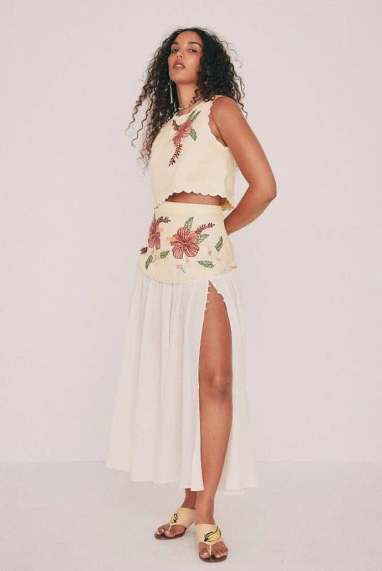 Cut from soft cotton crepe, this cream midi skirt falls from a fitted linen yoke carrying hand-drawn Paloma embroidery. A high split, fastened with buttons, lends movement, while a concealed zip sits at the centre back. The skirt that makes a plain white tee look considered, or choose to style it with the coordinating top and wear it to a summer wedding. This one won't last, add to cart before it's gone. Designed from a 6 to a 22.