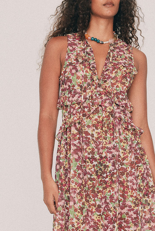 Cut from soft crepe georgette, this printed maxi dress skims the bust and waist before loosening through the hip. Ruffles run beneath the bust, at the waist and along the hem, while a low V neckline ties at the front with self rouleau. The Ola ditsy floral was drawn by hand in our Central Coast studio. Pockets sit in the side seams. A wedding guest dress that will also carry a long lunch. Pair with a vintage platform and chandelier earrings. Designed from a 6 to a 22.