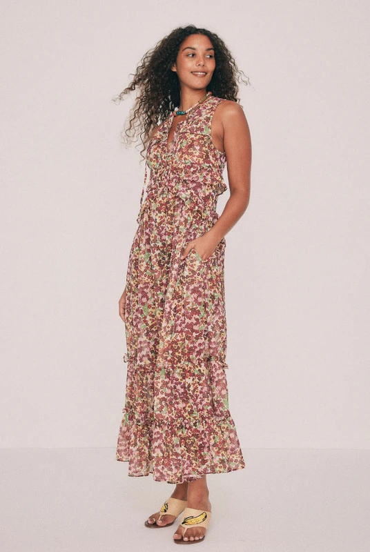 Cut from soft crepe georgette, this printed maxi dress skims the bust and waist before loosening through the hip. Ruffles run beneath the bust, at the waist and along the hem, while a low V neckline ties at the front with self rouleau. The Ola ditsy floral was drawn by hand in our Central Coast studio. Pockets sit in the side seams. A wedding guest dress that will also carry a long lunch. Pair with a vintage platform and chandelier earrings. Designed from a 6 to a 22.