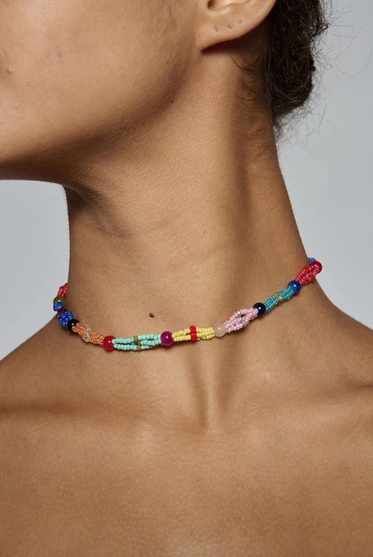 Hand beaded in a twisted multi-colour design, this artisanal choker sits close at the neck at forty centimetres. It is what finishes a plain linen dress for dinner. One size.
