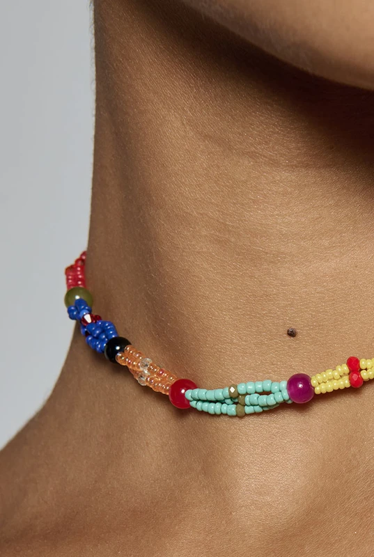 Hand beaded in a twisted multi-colour design, this artisanal choker sits close at the neck at forty centimetres. It is what finishes a plain linen dress for dinner. One size.