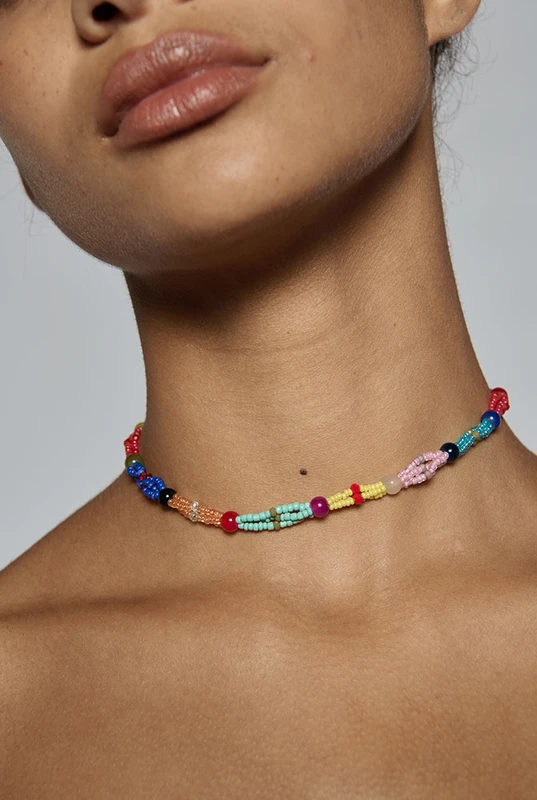 Hand beaded in a twisted multi-colour design, this artisanal choker sits close at the neck at forty centimetres. It is what finishes a plain linen dress for dinner. One size.