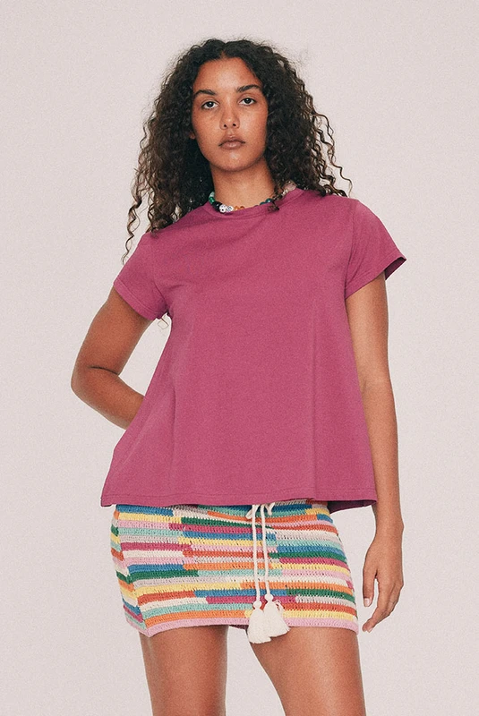 This Magenta tee has a relaxed swing silhouette with cap sleeves. Machine washable and quietly indispensable: wear it with the crochet skirt all summer. Designed from a 6 to a 22.