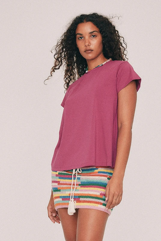 This fuchsia tee has a relaxed swing silhouette with cap sleeves. Machine washable and quietly indispensable: wear it with the crochet skirt all summer. Designed from a 6 to a 22.