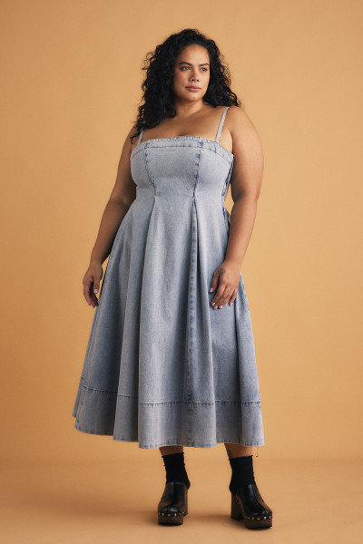 This 'Kylie' dress has a fit-and-flare silhouette that moves with every step. Suspended from slim, adjustable straps, it's made from panels of denim in a faded wash and has flexible shirring at the back and discreet pockets along the seams of the voluminous skirt.