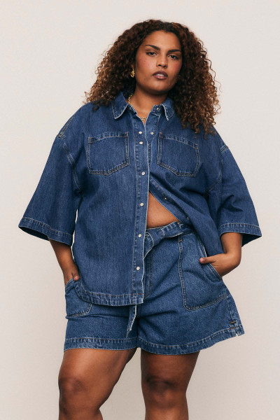 A cool classic, this oversized denim shirt channels effortless casual with a soft curve hem, chest patch pockets, and short sleeves. Made from premium cotton denim with just the right weight, it’s a wardrobe essential that pairs beautifully with everything from shorts to tailored pants. A cool classic, this oversized denim shirt channels effortless casual with a soft curve hem, chest patch pockets, and short sleeves. Made from premium cotton denim with just the right weight, it’s a wardrobe essential that pairs beautifully with everything from shorts to tailored pants.