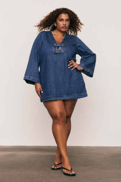 The Denim Shift Mini is a playful yet polished piece, designed with a gently fitted bust and loose hip for flattering ease. Crafted from premium cotton denim with a low V neckline and long sleeves, it features side pockets and a centre back zip - perfect for those casual days when you want to feel put together without effort.