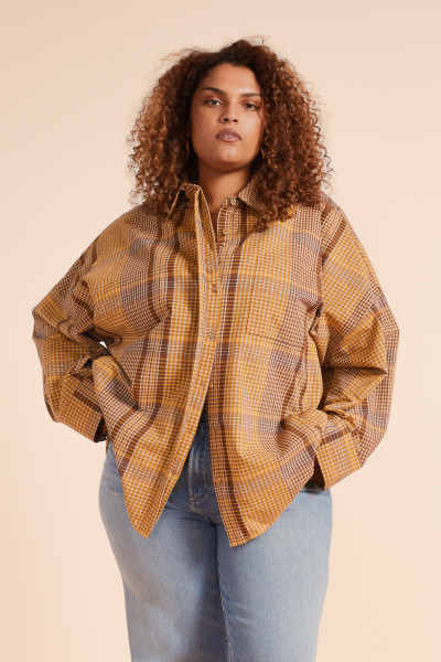 The Plaid Oversized Shirt in chocolate check is your go-to layer for laid-back styling. Cut from premium heavyweight cotton, it features a classic collar, full-length sleeves, and a relaxed silhouette. Wear it open over a dress or buttoned up with denim for effortless, everyday ease.