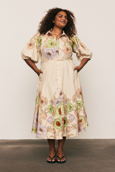 This premium linen blend midi dress is a study in effortless volume and artful print. Intended for a fluid, loose fit, the silhouette is balanced by a classic collar and a smooth button-down front, allowing the fabric to drape beautifully. Voluminous puff sleeves and a flowing midi skirt showcase the custom-designed floral placement print. This is a graceful, seasonless piece that combines comfort with sophistication, ensuring ultimate longevity in your modern capsule wardrobe.