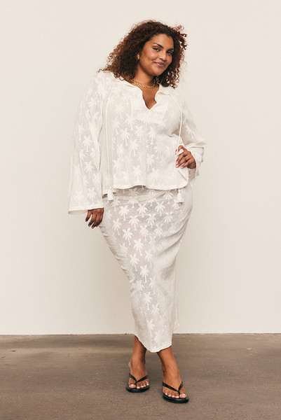 The Cotton Lace Maxi Skirt captures quiet elegance in motion. Cut from a premium cotton-blend knit lace with a refined palm motif, it’s designed with an elasticated waist and fluid drape that flatters effortlessly. Wear it with the matching Cotton Lace Swing Top for a feminine, textural look that feels timeless and beautifully modern.