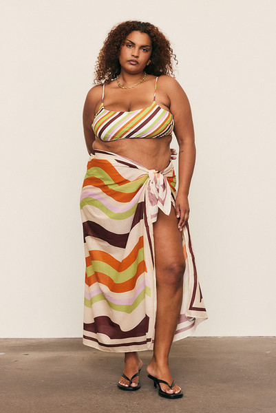 Light and versatile, the Maggie Stripe Sarong is crafted from premium cotton voile and printed with Bohemian Traders’ custom in-house stripe design. Designed to pair seamlessly with the matching bikini set, it drapes beautifully as a wrap, skirt, or cover-up. A timeless, size-inclusive accessory for effortless resort dressing and warm summer days. Light and versatile, the Maggie Stripe Sarong is crafted from premium cotton voile and printed with Bohemian Traders’ custom in-house stripe design. Designed to pair seamlessly with the matching bikini set, it drapes beautifully as a wrap, skirt, or cover-up. A timeless, size-inclusive accessory for effortless resort dressing and warm summer days.
