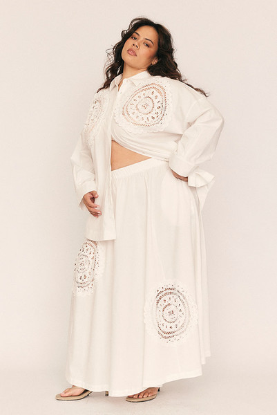 A warm-weather statement with timeless ease, the Crochet Circle Skirt is cut from crisp white cotton poplin and adorned with delicate lace crochet detailing for a softly romantic finish. The circular silhouette creates a natural fullness that moves beautifully with every step, while an elasticated waistband ensures all-day comfort.