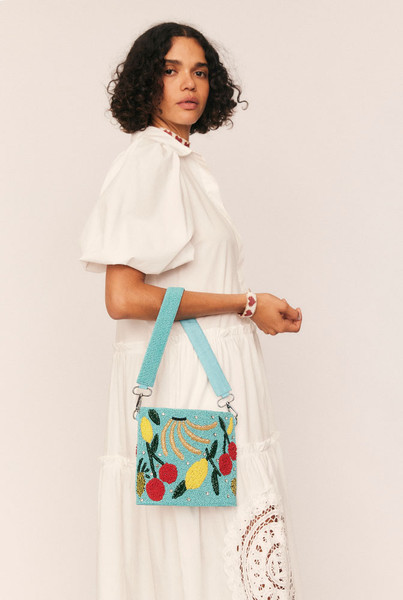 A joyful celebration of craftsmanship, the Fruity Beaded Handbag is an artisanal piece that turns every outfit into a statement. Featuring a hand-beaded fruit motif, multi-coloured tassels, and a removable wide shoulder strap—also intricately beaded—this compact carryall is full of character.