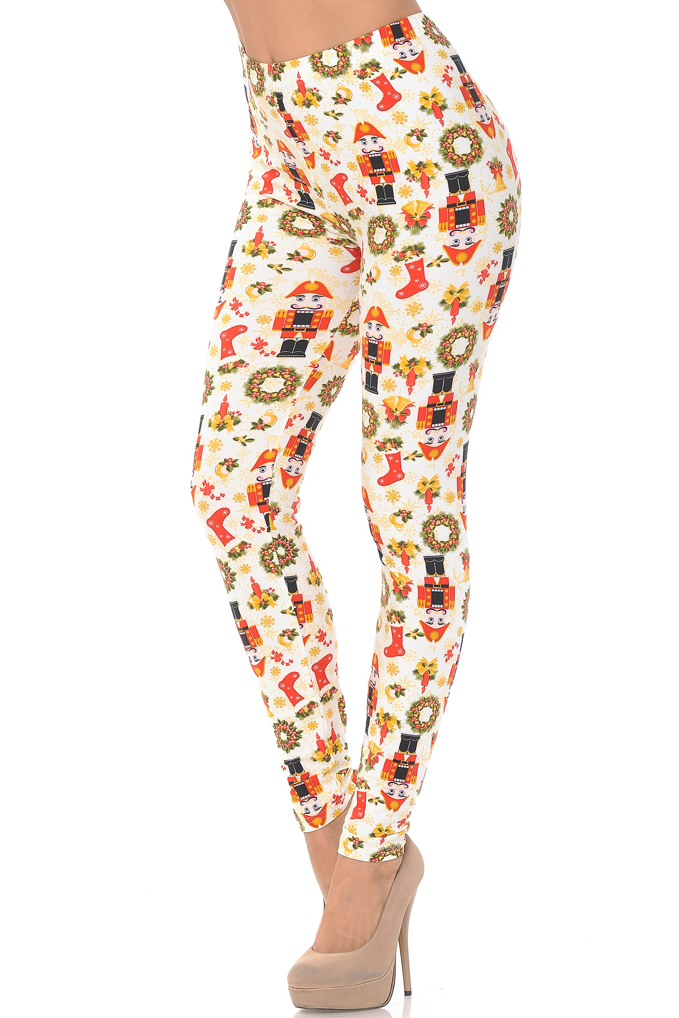 Left side right bent knee image of Buttery Soft Festive Ivory Christmas Plus Size Leggings featuring a colorful vintage looking design of nutcrackers, wreaths, stocking and candles on an ivory background.