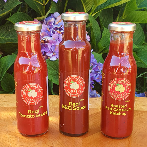Three-Sauce Trifecta Pack featuring Tomato, BBQ, and Plum sauces in glass jars with artisanal labels.
