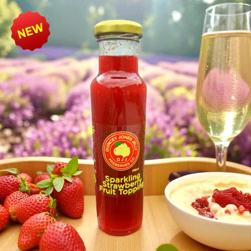 Front view of Sparkling Strawberry Fruit Topping bottle with strawberries and champagne