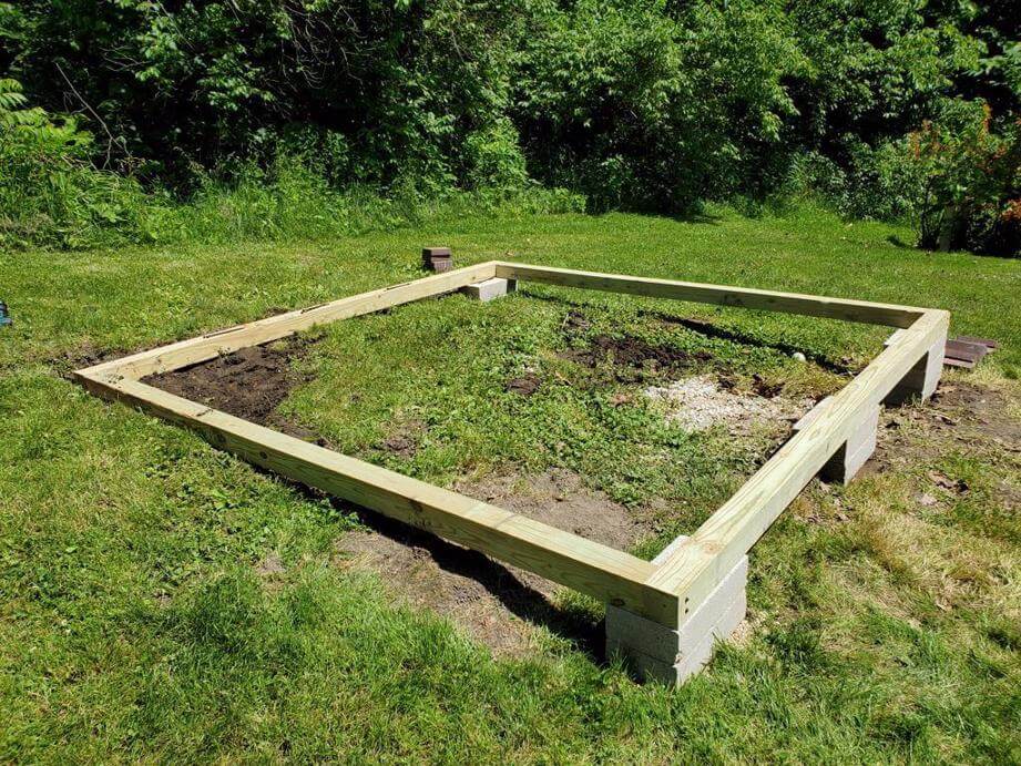 Treated 4x4 wood frame on concrete blocks under a shed