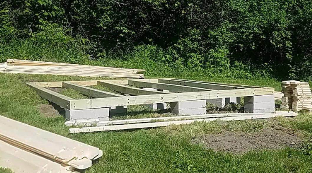Concrete block and treated wood shed foundation