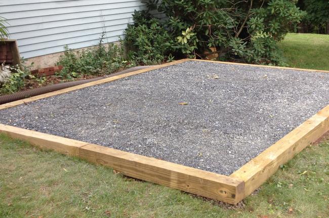 Treated wood frame filled with gravel as a shed foundation