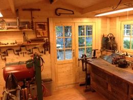 Opima 12 x 12 storage shed inside workshop