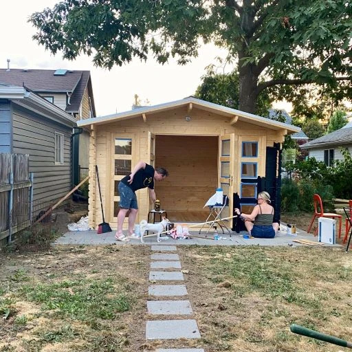 A prefabricated wood garden shed kit mid-assembly