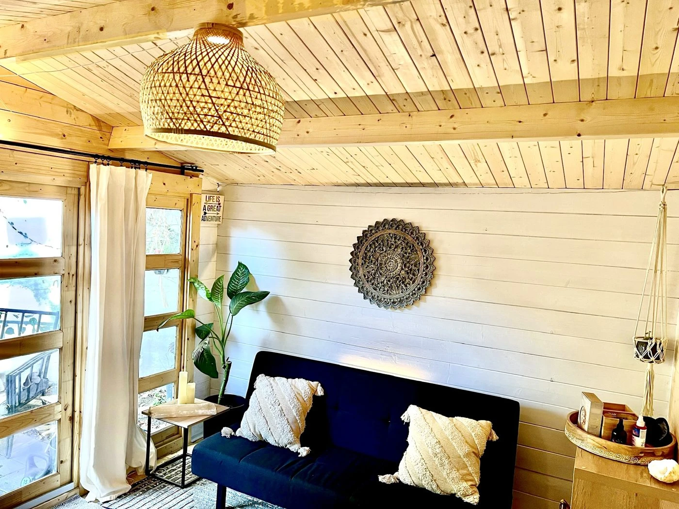 Boho-styled shed retreat with wood ceiling and shiplap walls