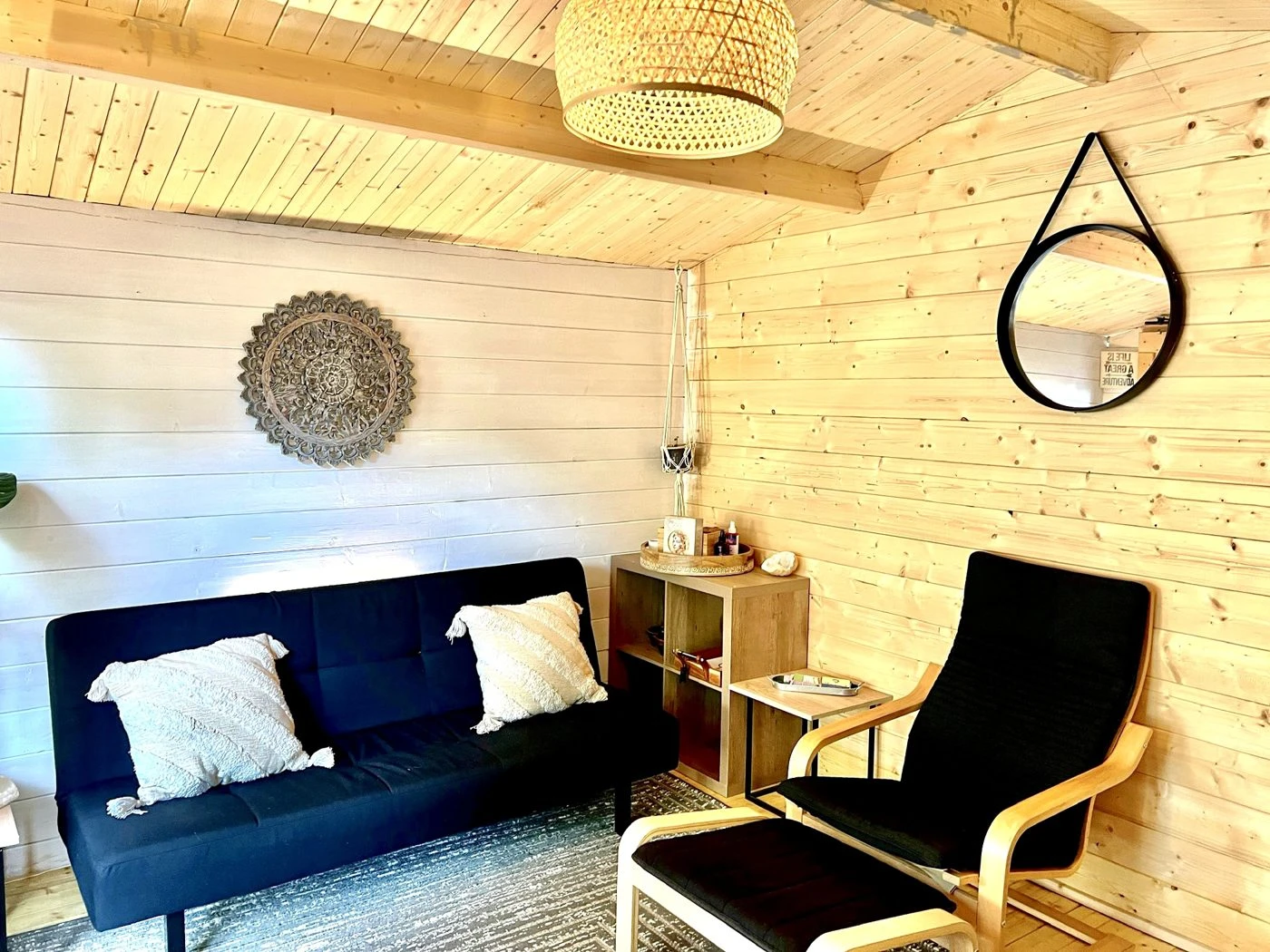 Wood-panelled shed interior styled as a hobby and lounge space