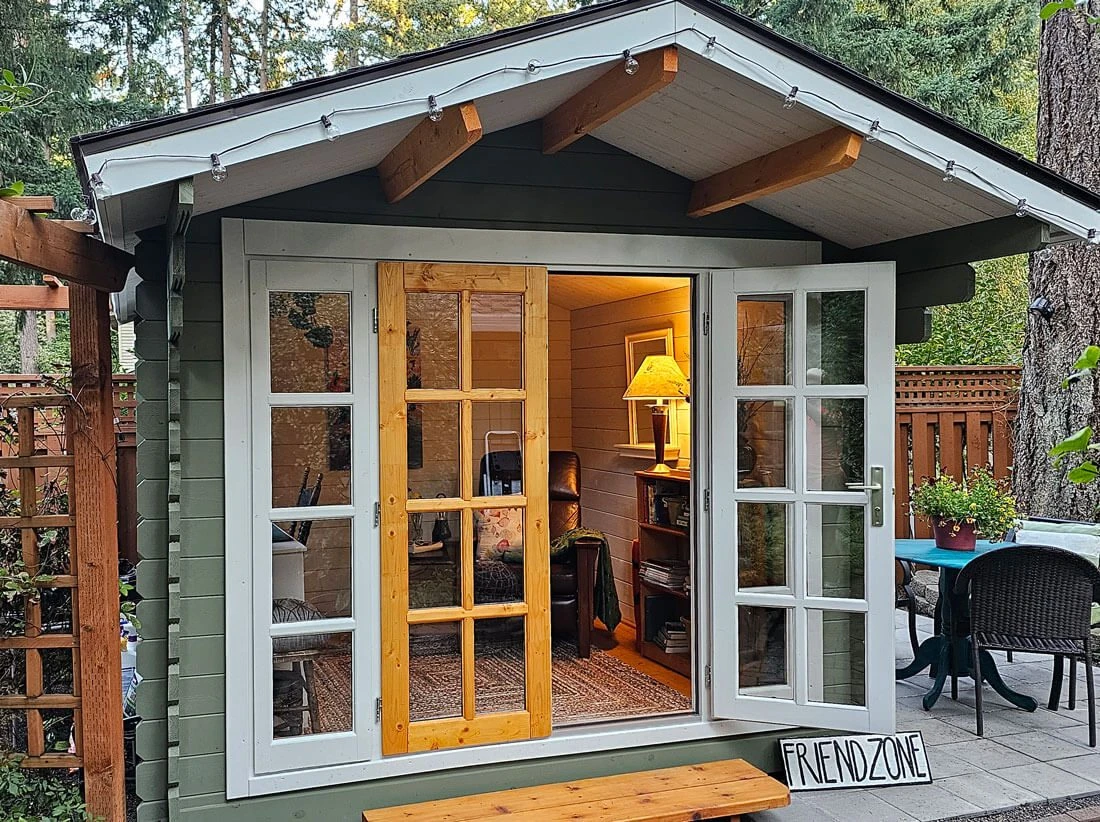 She shed on a patio in a wooded backyard at golden hour